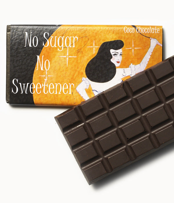 No Sugar No Sweetener 99% Cacao Mass – Hazelnut and Seasalt by Coco Chocolate chocolate bar with orange wrapper and dark cocoa squares