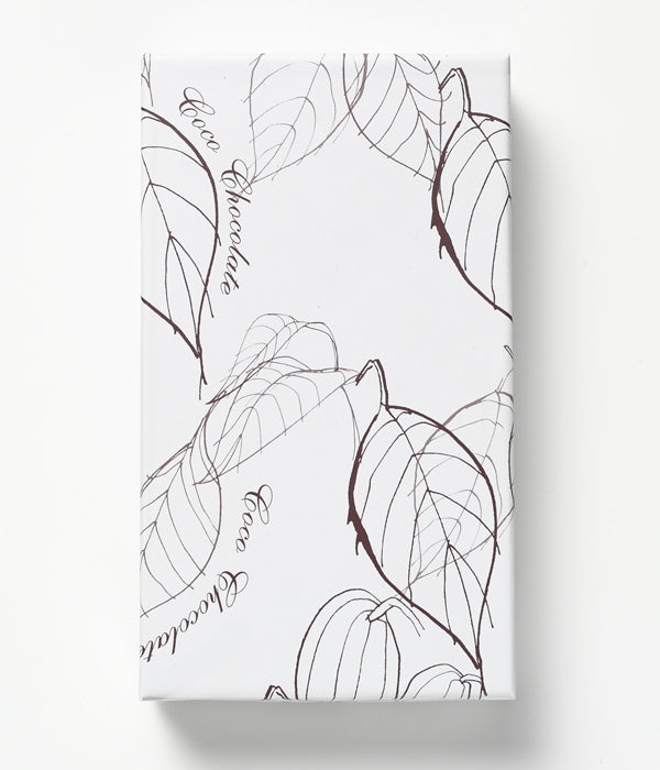 Milk Chocolate Bar Coco Chocolate artisan chocolate in a white wrapper with smooth texture and leaf line art