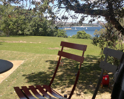Outdoor setting with chairs, table, and view of water and trees